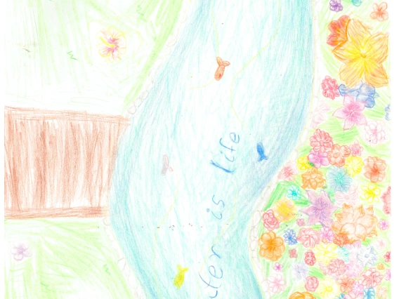 A stream going through a meadow says "Water Is Life!"